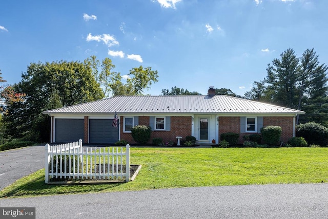 ranch-style house featuring a garage and a front lawn