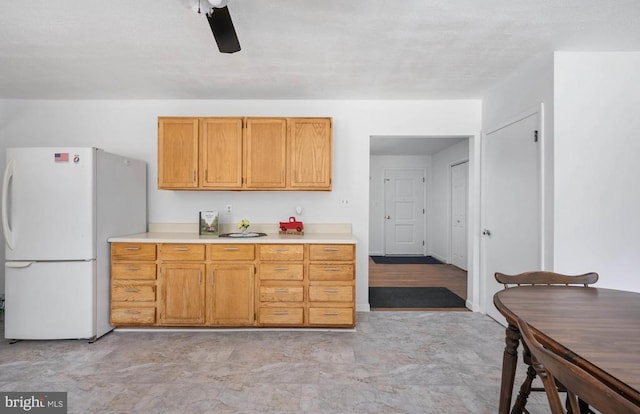 kitchen featuring ceiling fan and white refrigerator