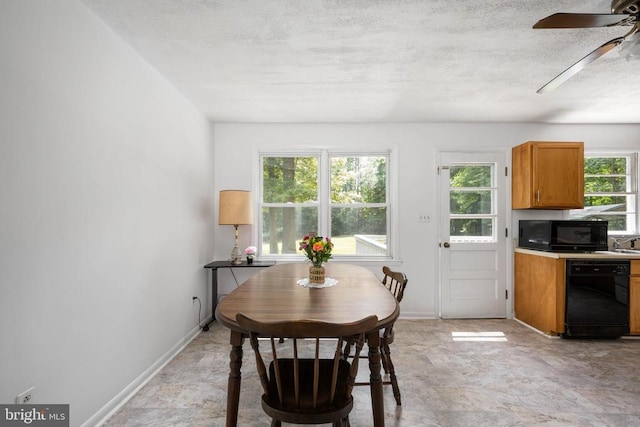 dining space featuring a textured ceiling, ceiling fan, and sink