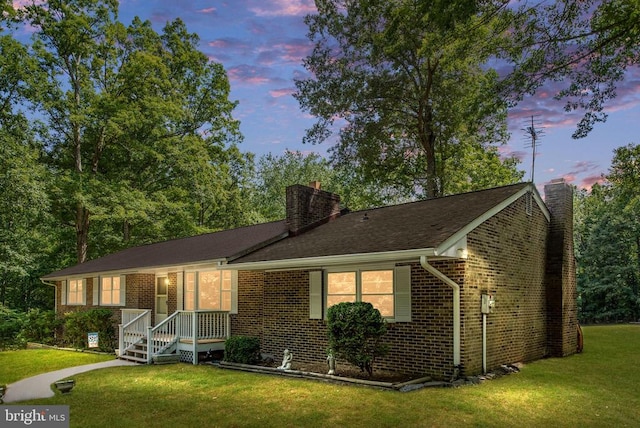 ranch-style home with a yard