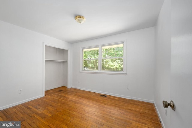 unfurnished bedroom featuring a closet and wood-type flooring