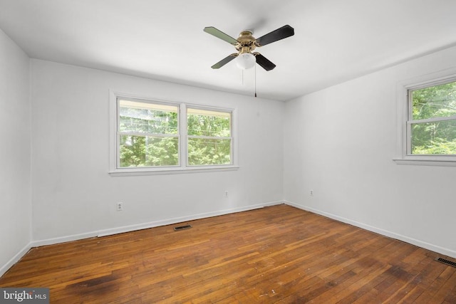 spare room with hardwood / wood-style flooring and ceiling fan