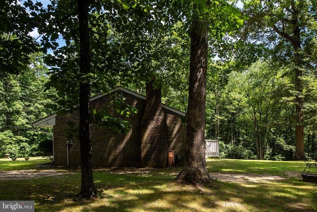 view of side of property with a yard