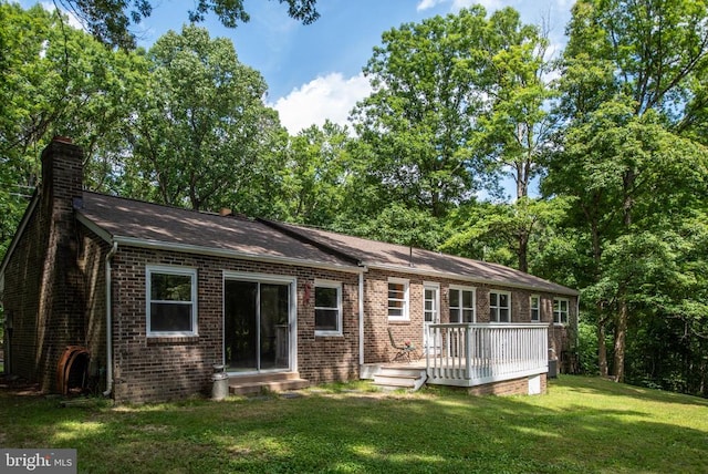 exterior space featuring a front lawn and a deck