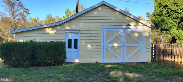 view of outdoor structure featuring a lawn