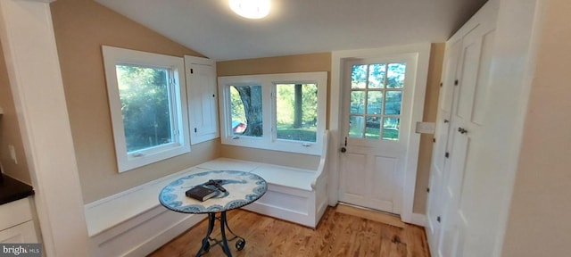 doorway featuring lofted ceiling and light hardwood / wood-style floors