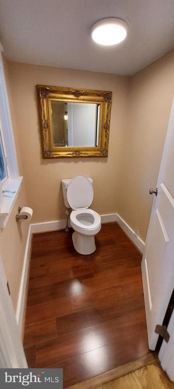 bathroom featuring wood-type flooring and toilet