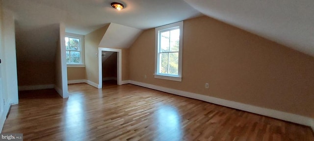 bonus room with vaulted ceiling and light hardwood / wood-style floors