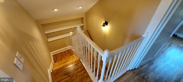 stairs with hardwood / wood-style flooring and vaulted ceiling