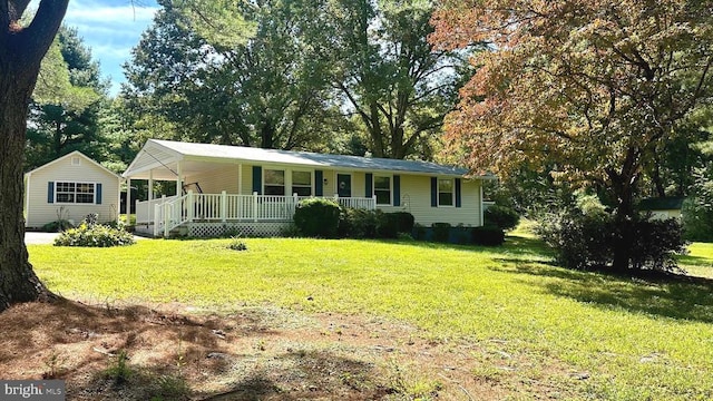 ranch-style house with a front yard and covered porch