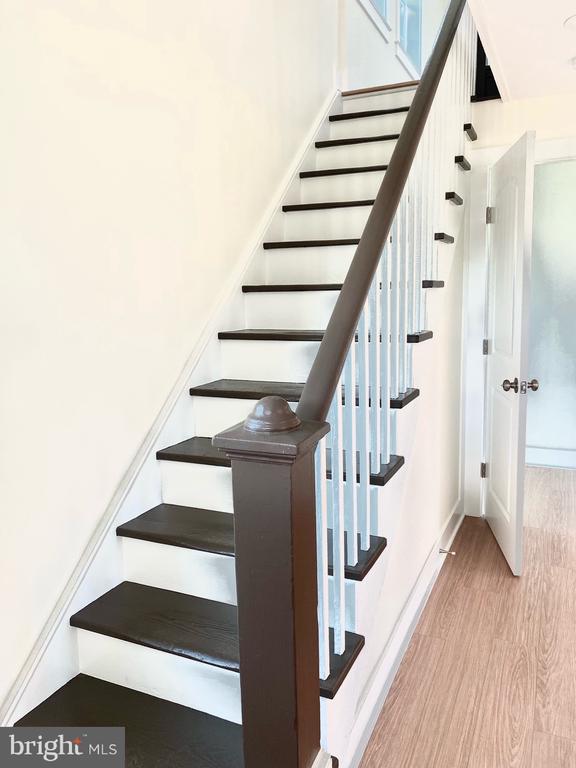 staircase with hardwood / wood-style floors