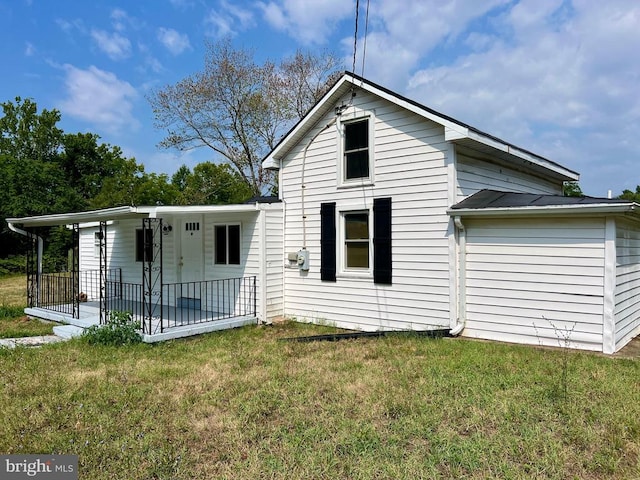 rear view of house with a lawn