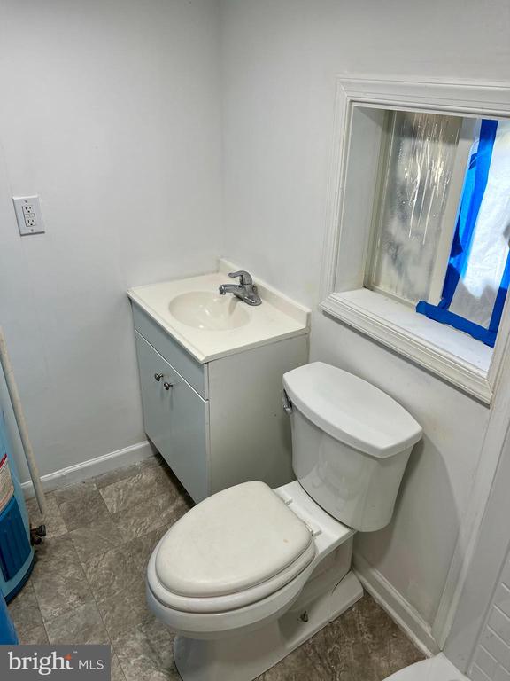 bathroom featuring toilet and vanity