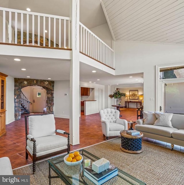 tiled living room featuring high vaulted ceiling and wood ceiling