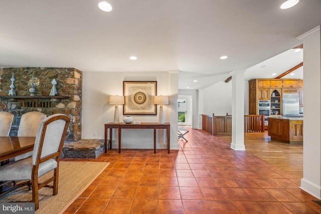 foyer with ornate columns and tile patterned floors