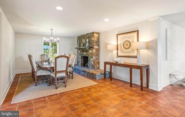 dining area with a fireplace, an inviting chandelier, and tile patterned floors