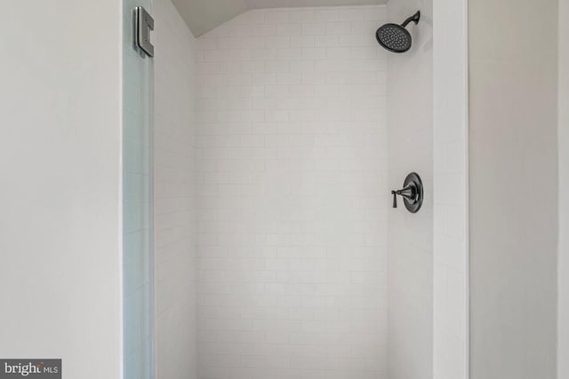 interior details featuring tiled shower