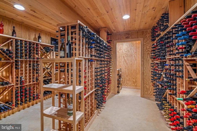 wine area featuring wooden ceiling and wooden walls