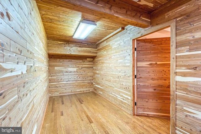 bonus room featuring wooden ceiling, wooden walls, and light hardwood / wood-style flooring