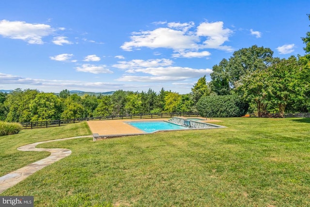 view of pool with a lawn