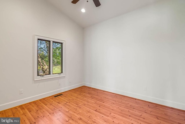 empty room with light hardwood / wood-style floors, ceiling fan, and high vaulted ceiling