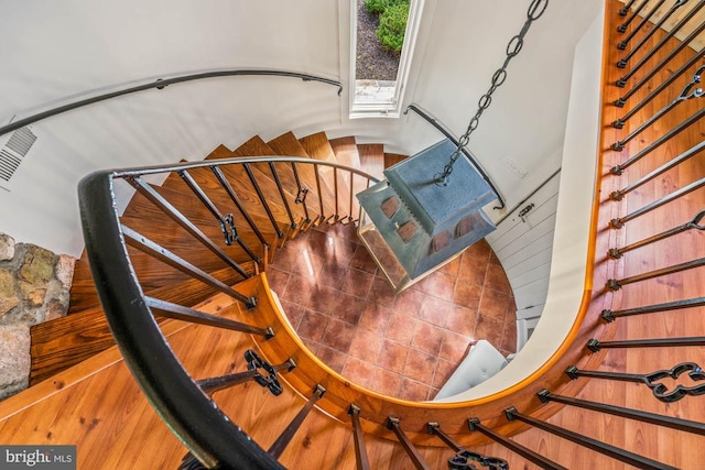 stairs with hardwood / wood-style flooring