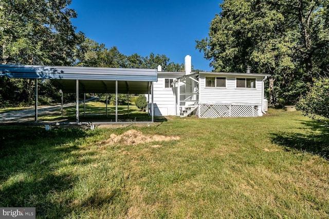 rear view of house featuring a yard