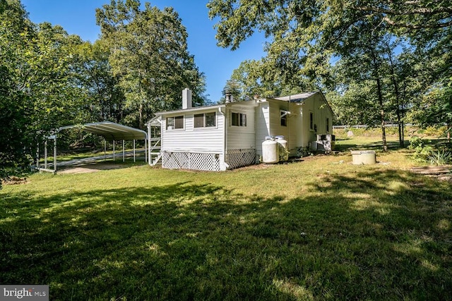 exterior space with a lawn and a carport