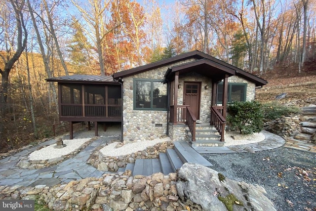 view of front of house with a sunroom