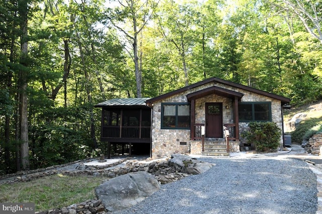 view of front of house with a sunroom