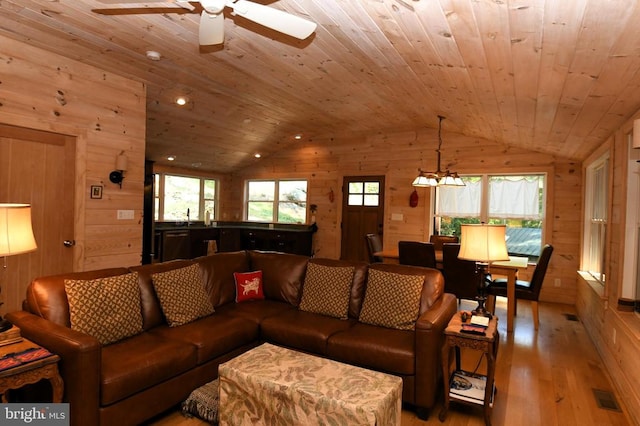 living room with ceiling fan, lofted ceiling, wood ceiling, and wood-type flooring