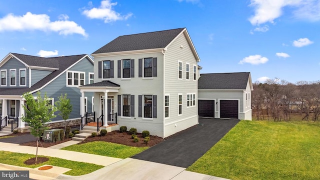 view of front of house featuring a front lawn, central AC unit, and a garage