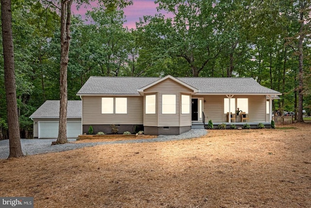 view of front of home with an outdoor structure, a porch, and a garage