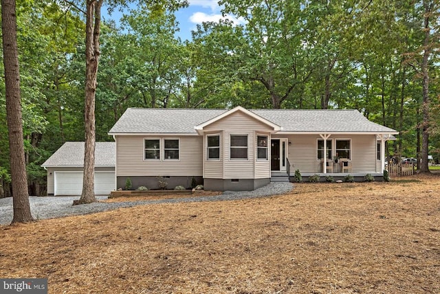 view of front facade with a garage, an outdoor structure, and covered porch