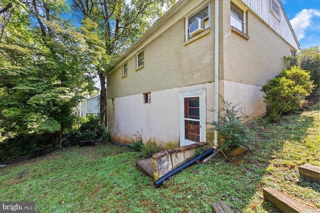 view of side of home with a yard