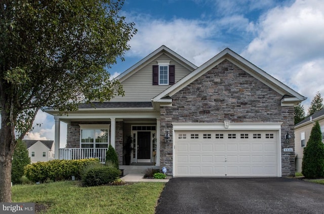 craftsman inspired home with covered porch and a garage