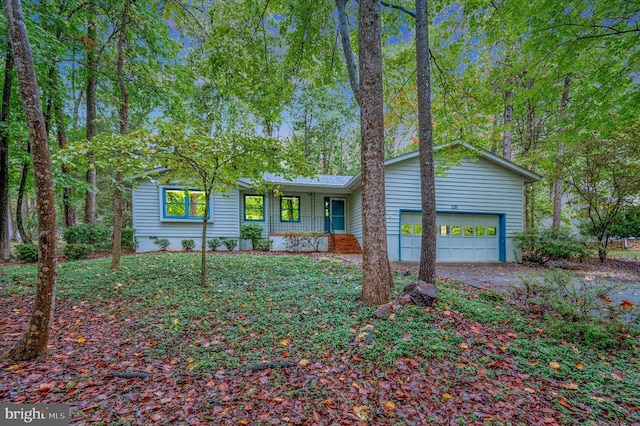 single story home with a garage and covered porch