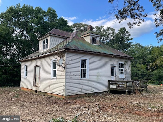 view of home's exterior with a wooden deck