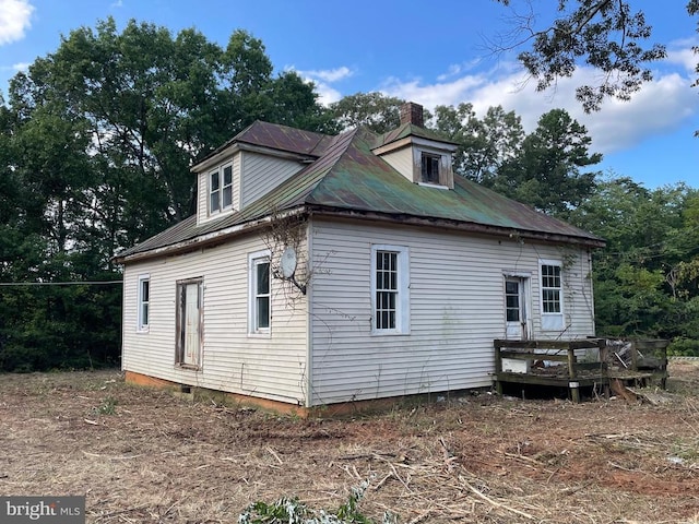 view of property exterior featuring a wooden deck