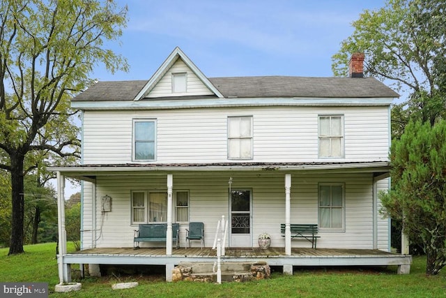 view of front of house with covered porch and a front yard