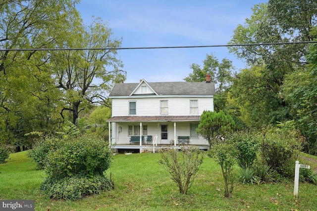 view of front of property with covered porch and a front yard