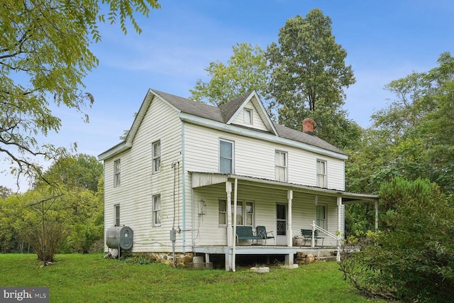 view of front of house featuring a front yard and a porch