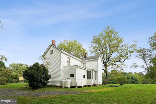 view of side of property with a yard