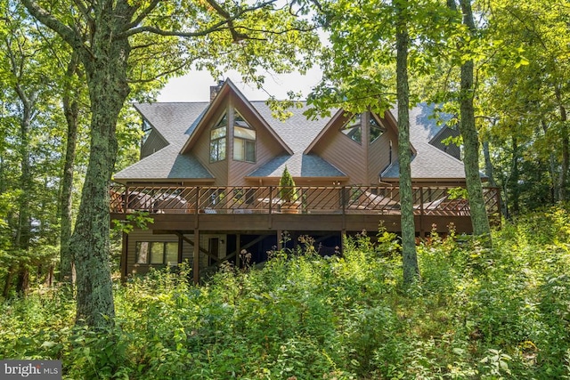 back of house featuring a wooden deck