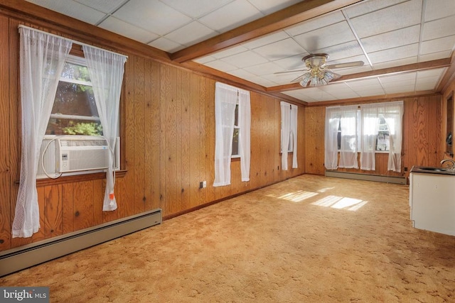 unfurnished room featuring ceiling fan, light carpet, and a baseboard heating unit