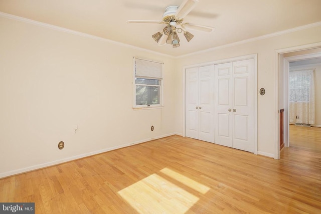 unfurnished bedroom featuring wood-type flooring, ornamental molding, a closet, and ceiling fan