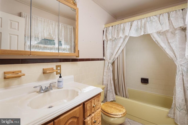 full bathroom featuring toilet, tile walls, shower / tub combo with curtain, ornamental molding, and vanity