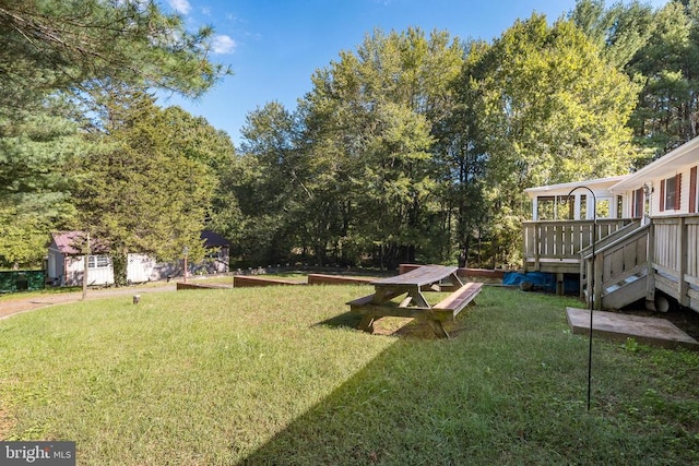 view of yard with a storage shed and a wooden deck