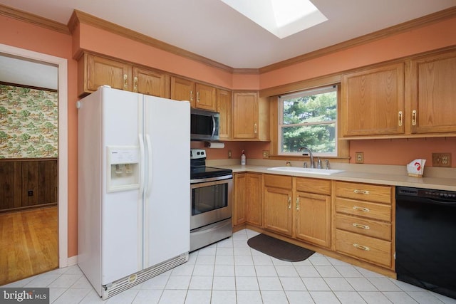 kitchen with ornamental molding, appliances with stainless steel finishes, sink, and light tile patterned floors