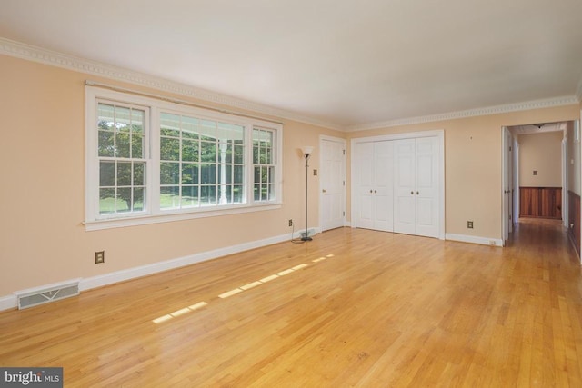 unfurnished room with wood-type flooring and crown molding